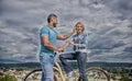 How to meet girls while riding bike. Man with beard and shy blonde lady on first date. Picking up girl. Couple just meet Royalty Free Stock Photo