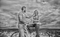 How to meet girls while riding bike. Man with beard and shy blonde lady on first date. Picking up girl. Couple just meet Royalty Free Stock Photo