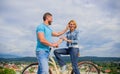 How to meet girls while riding bike. Man with beard and shy blonde lady on first date. Picking up girl. Couple just meet Royalty Free Stock Photo