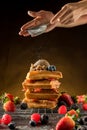 Ã Â¹â¡How to powdering traditional homemade waffles with icing sugar. Waffles with ice cream, caramel sauce and fresh berries. Royalty Free Stock Photo