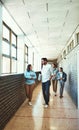 How was class. Full length shot of a group of university students walking through a campus corridor. Royalty Free Stock Photo