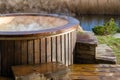 How water swirling in wooden hot tub outside in nature. Enjoying hot steaming pool on a sunny day, private spa treatment. Nobody Royalty Free Stock Photo