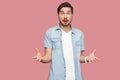 How you did this? Portrait of shocked sad bearded young man in blue casual style shirt standing with stressed face and looking at Royalty Free Stock Photo