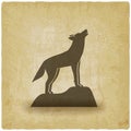 Howling wolf stands on rock vintage background