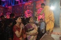 Hindu Bengali sari clad women praying to Goddess Durga inside Durga Puja pandal. Ashtami puja aarati at night. Biggest fetsival of Royalty Free Stock Photo