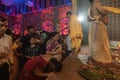 Hindu Bengali sari clad women praying to Goddess Durga inside Durga Puja pandal. Ashtami puja aarati at night. Biggest fetsival of Royalty Free Stock Photo