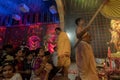 Hindu Priest blessing praying devotees with chamor, fly whisk fan inside Durga Puja pandal. Ashtami puja aarati at night. Biggest Royalty Free Stock Photo