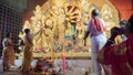 Howrah, West Bengal, India - 5th October, 2022 : Divine Shahkh naad, Hindu devotee woman blowing conch shell while Purohits