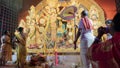 Howrah, West Bengal, India - 5th October, 2022 : Divine Shahkh naad, Hindu devotee woman blowing conch shell while Purohits