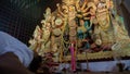 Howrah,West Bengal,India-5th October, 2022 : Hindu Purohit showing respect, praying and worshipping Goddess Durga, kneels down