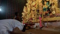 Howrah,West Bengal,India-5th October, 2022 : Hindu Purohit showing respect, praying and worshipping Goddess Durga, kneels down