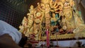 Howrah,West Bengal,India-5th October, 2022 : Hindu Purohit showing respect, praying and worshipping Goddess Durga, kneels down