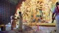Howrah, West Bengal, India - 5th October, 2022 : Hindu Purohits worshipping Goddess Durga , devotee with big hand fan airing her