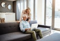 Hows the fibre speed honey. a mature couple using a laptop on the sofa at home. Royalty Free Stock Photo