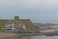 Howth harbor with sailing boat and Martello tower on a cliff