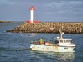 Howth Lighthouse. Fishing boat on Irish sea