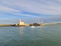 Howth Lighthouse. Fishing boat on Irish sea