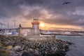 Howth Lighthouse with flying seagulls at beautiful sunset Royalty Free Stock Photo