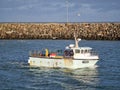 Howth Lighthouse. Fishing boat on Irish sea