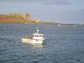 Howth Lighthouse. Fishing boat on Irish sea