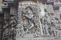 Hoysaleswara Temple outer wall carved with sculpture of Lord Krishna playing flute