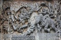 Hoysaleswara Temple outside wall carved with sculpture of Lord Indira chasing Lord krishna for stealing parijatha flower