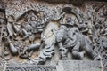 Hoysaleswara Temple outside wall carved with sculpture of Lord Indra chasing Lord krishna for stealing parijatha flower