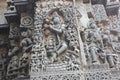 Hoysaleswara Temple outside wall carved with sculpture of Lord krishna playing flute
