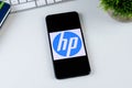 HP Print Service Plugin app logo on a smartphone screen.