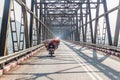 HPA AN, MYANMAR - DECEMBER 13, 2016: Local man on a heavily loaded motorbike crosses a bridge over Thanlwin Thanlyin river near Royalty Free Stock Photo