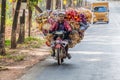 HPA AN, MYANMAR - DECEMBER 13, 2016: Local man on a heavily loaded motorbike near Hpa A Royalty Free Stock Photo