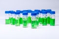 HPLC vials with green sample of plant extracts. Developing of drugs based on natural products. Biochemical analysis