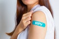 HPV Human Papillomavirus Teenager woman showing off an blue bandage after receiving the HPV vaccine.viruses Some strains infect