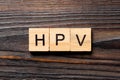 HPV word written on wood block. HPV text on wooden table for your desing, Top view concept Royalty Free Stock Photo