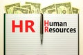 HR Human resources symbol. Concept words HR Human resources on white note. Metallic pen. Dollar bills. Beautiful white background Royalty Free Stock Photo