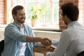 Hr manager employer shaking happy successful candidate hand at meeting