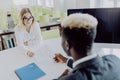 HR manager interviewing young woman in modern office