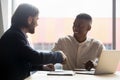 HR manager shaking hands with happy african american employee. Royalty Free Stock Photo