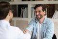 Hr manager shaking smiling man hand, congratulating successful candidate