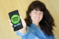 Young woman using popular music service SPOTIFY