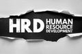 HRD Human Resource Development acronym under torn paper. Distressed bold letters highlight corporate and organizational training Royalty Free Stock Photo
