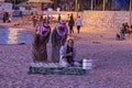 hree Arabic men in ethnic clothes are performing the evening prayer