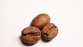 Hree coffee beans on a white table