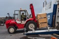 Worker using a forklift to move fish on board a ferry