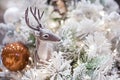 hristmas deer with a decorative ball on a christmas branch. Festive christmas