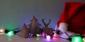 hristmas tree and deer next to santa hat Royalty Free Stock Photo