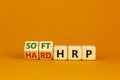 HRP, human resource planning symbol. Turned wooden cubes and changed words hard HRP to soft HRP. Beautiful orange background.