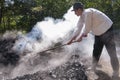 HRUSOV, SLOVAKIA - AUGUST 16: Young worker in traditional costume makes charcoal during folklore festival Hontianska Parada on Aug