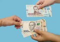 500 and 1000 hryvnia in female hands. The concept of corruption. to give a bribe. Giving or taking money. Hands with hryvnias isol