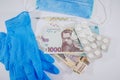 Hryvnia and medicines, virus protection products, mask, gloves on white. Medical concept.